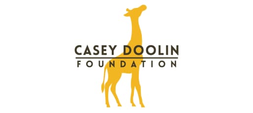 A giraffe standing next to the casey doolin foundation logo.